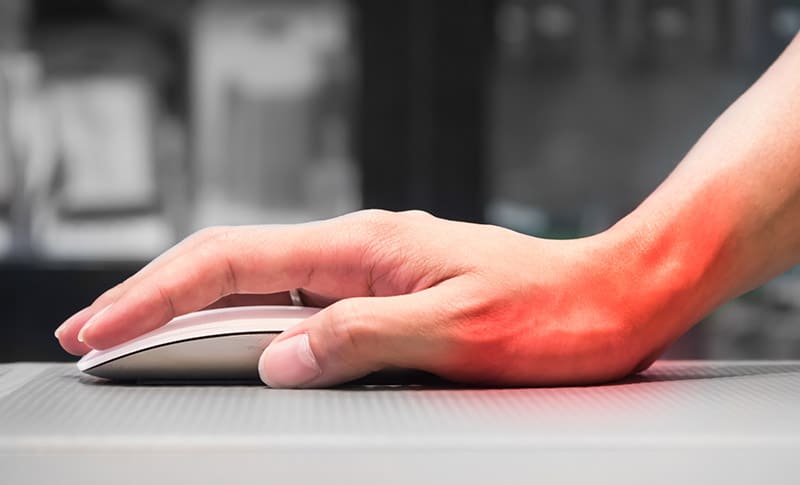 woman's hand on mouse representing carpal tunnel injury