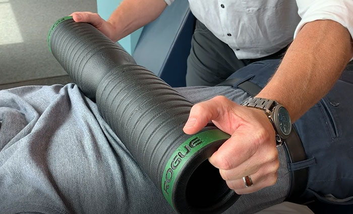 A rolling weight being applied by a provider on a patients back as a part of body tempering