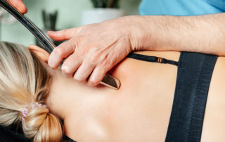 physical therapist using the [hGraston Technique