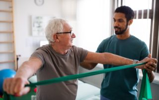physical therapist leading patient through therapeutic exercise