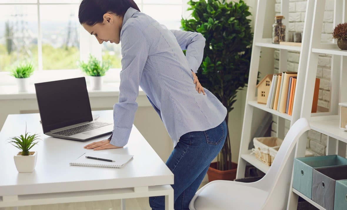 woman with sciatic nerve pain holding her back