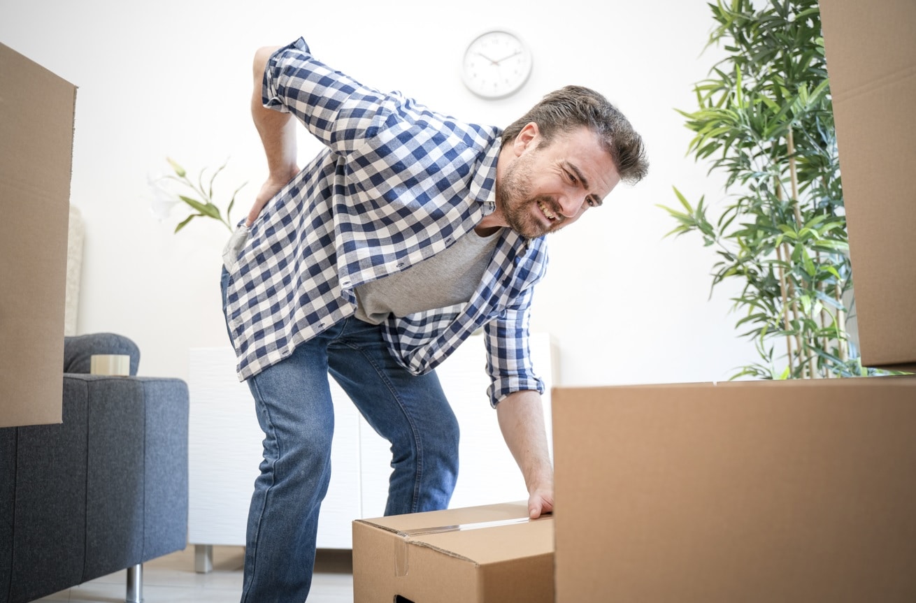 man lifting a heavy box, needs good lifting habits to keep joints health