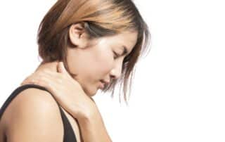 woman holding her neck in pain suffering from myofascial pain syndrome