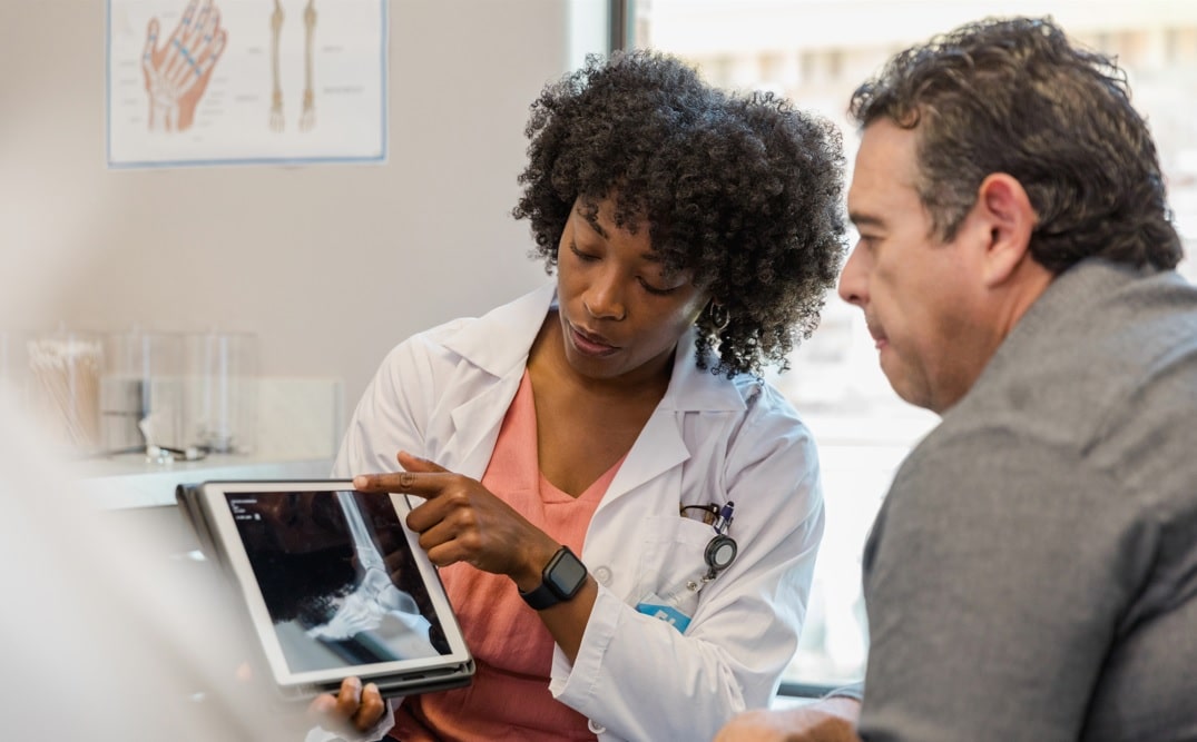 Female physician assistants in orthopaedics explaining an x-ray to a patient