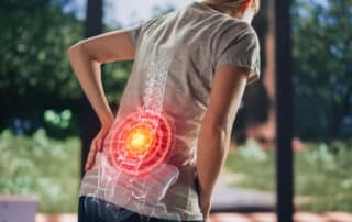 A senior female is experiencing discomfort due to arthritis of the spine (spinal arthritis).