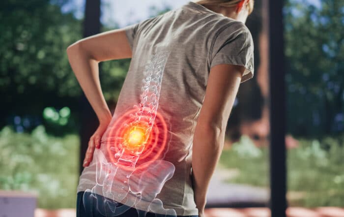 A senior female is experiencing discomfort due to arthritis of the spine (spinal arthritis).